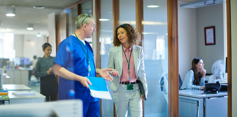 hospital administrator walking with nurse