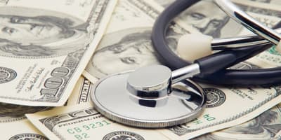 Stethoscope on a pile of money